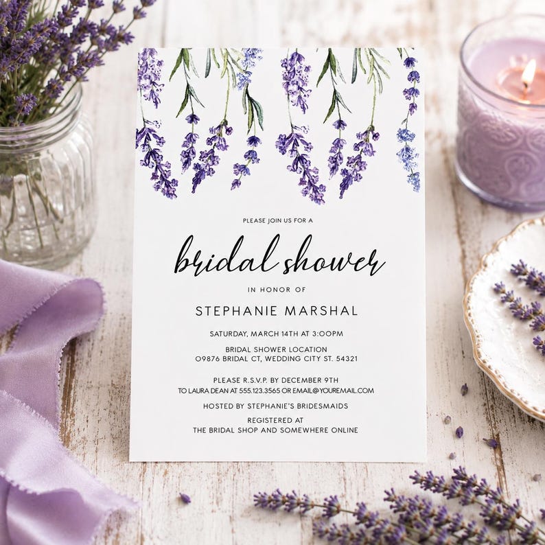 May include: A white rectangular bridal shower invitation card featuring a watercolor illustration of purple lavender sprigs at the top. The text reads: Please join us for a bridal shower in honor of Stephanie Marshal, Saturday, March 14th at 3:00pm.