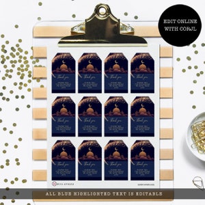 Peut inclure: Une feuille de douze &eacute;tiquettes cadeaux rectangulaires sur fond bleu fonc&eacute; avec un croissant de lune dor&eacute;, des &eacute;toiles et une silhouette de mosqu&eacute;e. Le texte indique : thank you, THANK YOU FOR SHOWERING ME WITH YOUR LOVE. Fix&eacute;e par un clip dor&eacute;.
