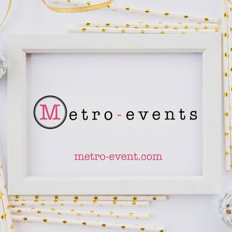 May include: A white rectangular picture frame containing a white sign with the black text Metro-events and the pink text metro-event.com. The letter M is inside a black circle. The frame is surrounded by white paper straws with gold stars.