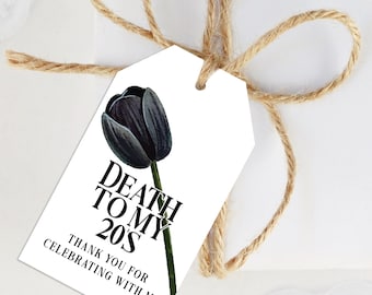 Puede incluir: Una etiqueta de regalo blanca con una ilustración de tulipán negro y el texto "Death to my 20s. Thank you for celebrating with me."