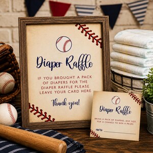 May include: A framed sign and a matching card with baseball themes, both featuring the text Diaper Raffle. The sign reads: If you brought a pack of diapers for the diaper raffle please leave your card here. Thank you! The card includes a name line.