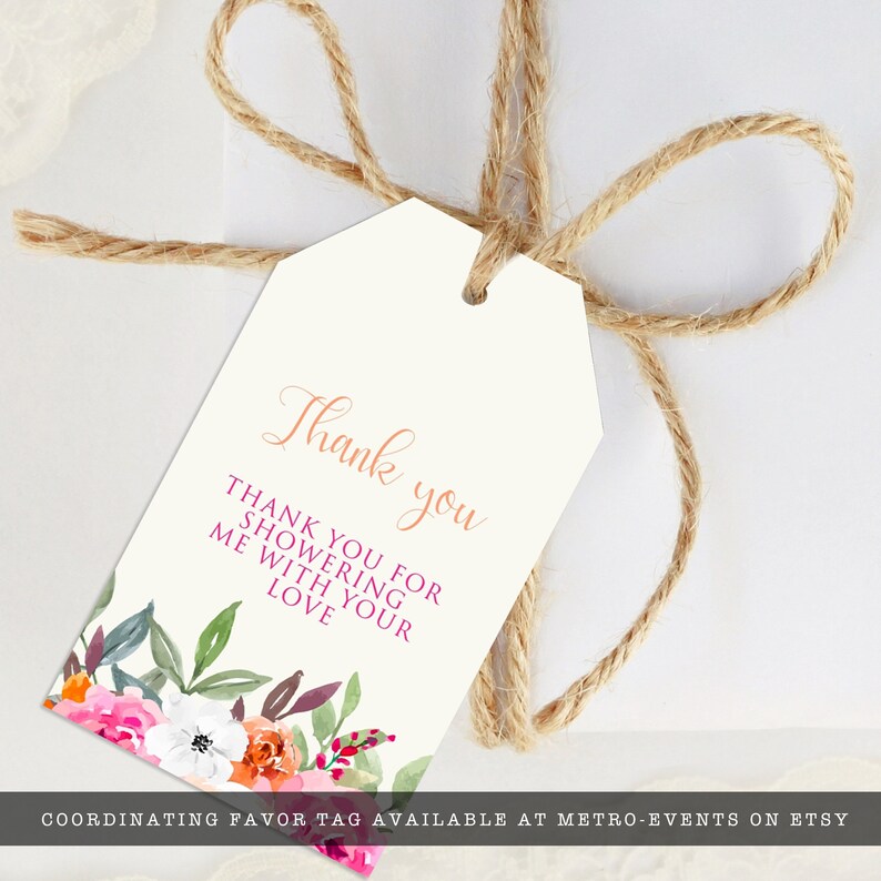May include: A cream-coloured gift tag with a floral design and the words "Thank you." The tag is tied with twine. The floral design includes pink, orange, and white flowers with green and purple leaves. The text "Thank you for showering me with your love" is also on the tag.