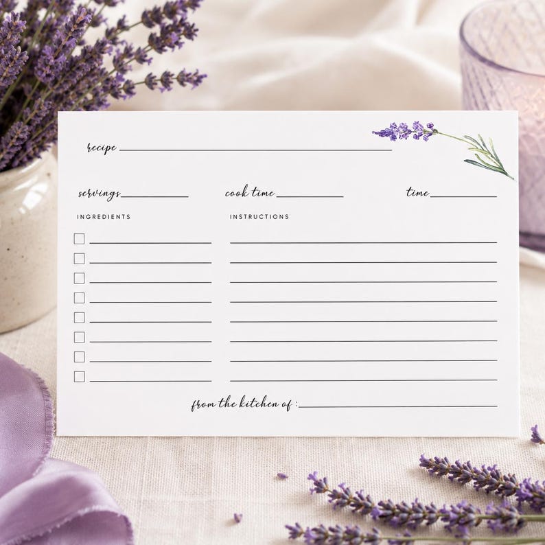 May include: A white rectangular recipe card featuring a lavender sprig illustration in the top right corner. The card includes printed lines and labels for recipe, servings, cook time, time, ingredients with checkboxes, instructions, and from the kitchen of.
