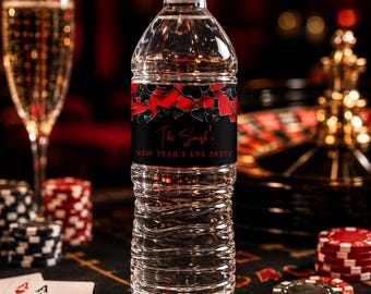 May include: A clear plastic water bottle with a white cap and a black label featuring red and black playing card suit symbols. The label text reads The Smith's NEW YEAR'S EVE PARTY in a red script and white sans-serif font on a black background.