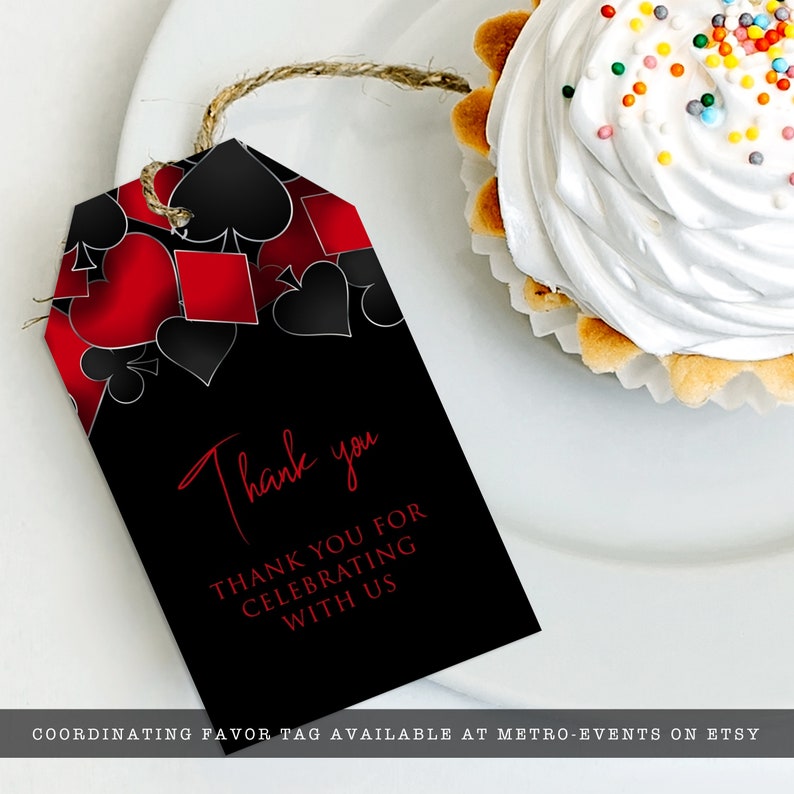 May include: A rectangular black gift tag with a twine string featuring a red and black playing card suit pattern at the top. The text reads Thank you and THANK YOU FOR CELEBRATING WITH US in red font. The tag is positioned next to a cupcake.
