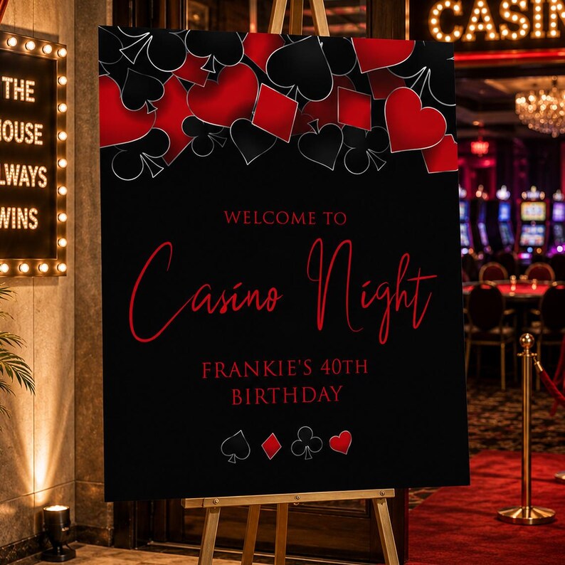 May include: A black rectangular sign on a wooden easel featuring red and white playing card suit symbols at the top and bottom. The text reads Welcome to Casino Night and Frankie's 40th Birthday in red and white lettering against a black background.