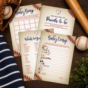 May include: Four rectangular paper game cards with a baseball theme, featuring red stitching graphics along the edges. The cards include Baby Bingo, How Old Were the Parents-to-be, What's In Your Purse, and Baby Emoji games with printed text and lists.