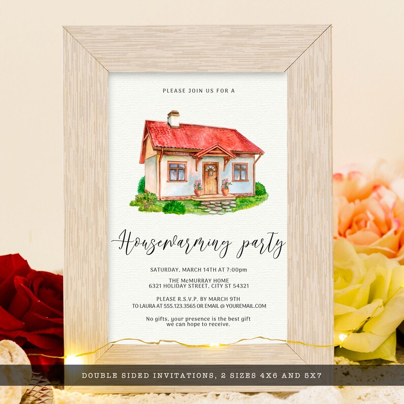 May include: A framed housewarming party invitation. The watercolor illustration features a house with a red roof and green grass. The invitation includes event details and RSVP information. The frame is light wood.