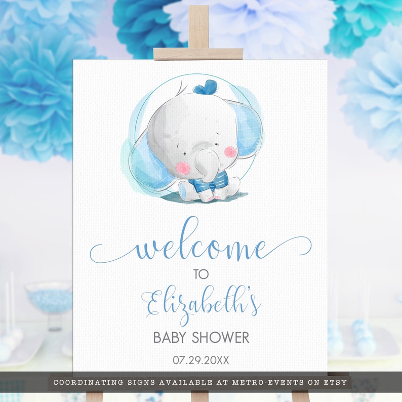 May include: A baby shower welcome sign featuring a watercolor illustration of a cute baby elephant in blue. The sign says "welcome to Elizabeth's BABY SHOWER 07.29.20XX". The sign is displayed on a wooden easel.