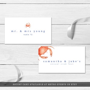 Crab Boil, Seafood Festival Escort Card. Featuring an orange watercolor crab with a blue striped back with a watercolor texture. Designed by MetroEvents.