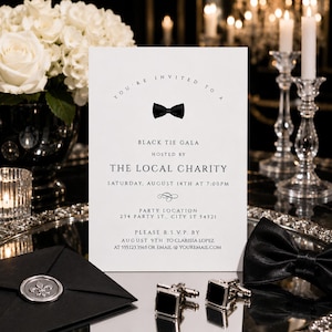 May include: A white rectangular invitation card with black text and a black bow tie graphic. The text reads: You're invited to a Black Tie Gala hosted by The Local Charity, Saturday, August 14th at 7:00pm, party location 234 Party St., City ST 54321.