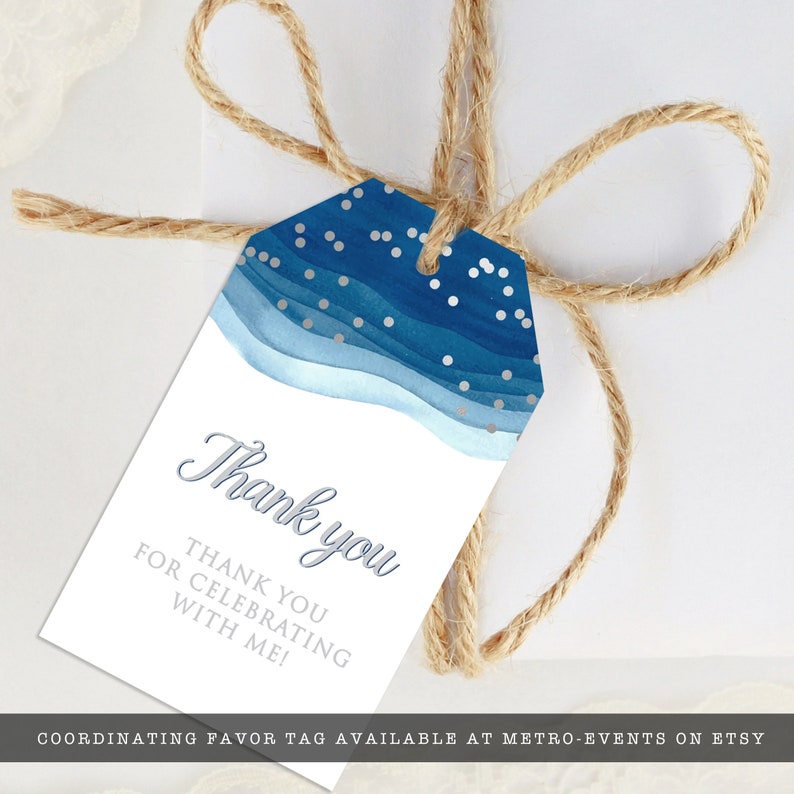 May include: A white gift tag with a blue watercolor design and silver accents, tied with twine. The tag reads "Thank you" and "Thank you for celebrating with me!"