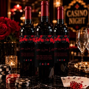 May include: Three wine bottles with red foil tops and black labels featuring red and black playing card suit symbols. The labels display the text Custom Wine Label and ADD THE WINE TYPE, DATE OR ANYTHING ELSE YOU WANT HERE in red lettering.