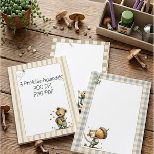 May include: Three rectangular notepads with white centers and patterned borders. One notepad features text reading 3 Printable Notepads 300 DPI PNG/PDF and a bear illustration. Another shows a squirrel with an acorn. The third has a checkered border.