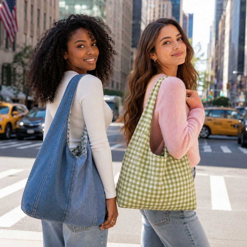 May include: A blue denim hobo bag with visible seams and a wide shoulder strap, and a light green and white gingham check fabric hobo bag with a wide shoulder strap. Both bags feature a soft, unstructured design for carrying personal items.