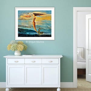 May include: A painting of a mermaid with flowing hair, a red tail, and a fish in her hand. The background is a blue and yellow sky with clouds. The painting is framed in white.