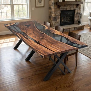 May include: A rectangular dining table featuring a live edge wood slab with a dark brown grain pattern and a central translucent gray resin inlay. The table is supported by a black metal X-shaped base and is accompanied by dark wooden chairs.