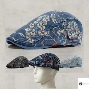 May include: A flat cap featuring a blue denim base with a white floral pattern. The cap has a structured brim and an adjustable strap with a metal buckle on the side. The design includes a rounded crown and a low-profile silhouette for a classic look.