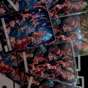 May include: A collection of rectangular trading cards featuring anime-style illustrations of fantasy characters in various settings. Each card includes a text box labeled TOKEN CREATURE with specific designations like BEAST or SQUIRREL.