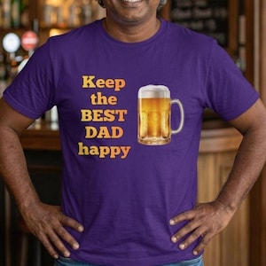 May include: A purple t-shirt with the text "Keep the BEST DAD happy" in yellow and orange. A graphic of a beer mug filled with beer is printed on the shirt.