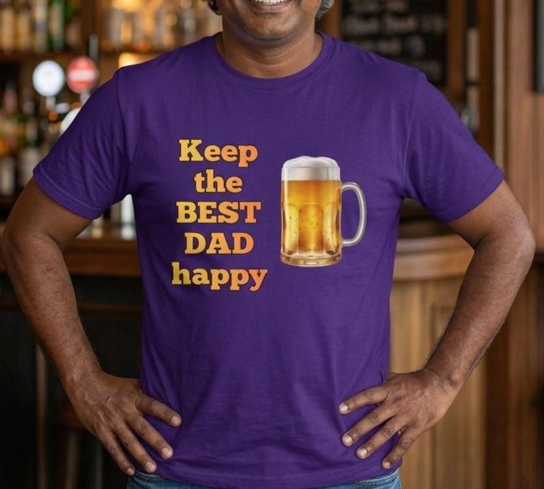 May include: A purple t-shirt with the text "Keep the BEST DAD happy" in yellow and orange. A graphic of a beer mug filled with beer is printed on the shirt.