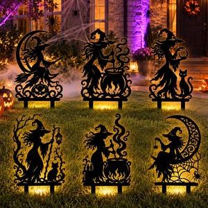 May include: A set of six black metal Halloween yard stakes featuring intricate silhouettes of witches, cauldrons, cats, and crescent moons. Each decorative stake is designed to be inserted into the ground, displaying detailed cut-out patterns.