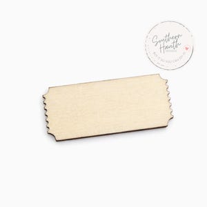 May include: A light-colored wooden ticket with a scalloped edge. The ticket is rectangular and has a natural wood grain. The image also includes a circular logo with the text "Southern Hauth Designs" and the phrase "Buy it so you can DIY it."