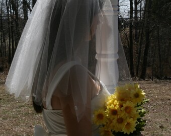 Two-tiered elbow length veil with sccalloped edge