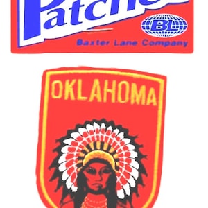 May include: Two iron-on patches. The top patch is red with the word "Patches" in blue and white, and the text "Iron On". The bottom patch is red with "OKLAHOMA" and a Native American design.