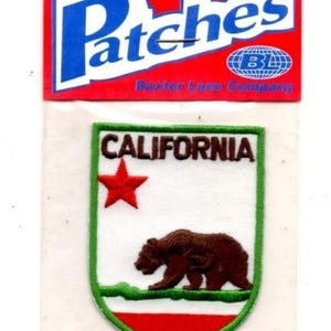 May include: Iron-on patch featuring the California state flag design. The patch has a white background with a brown bear, a red star, and the word "CALIFORNIA". The patch is bordered in green and red, with the word "Patches" at the top.