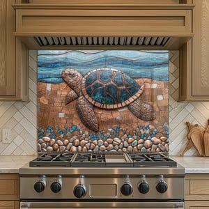 May include: A kitchen backsplash features a mosaic of a sea turtle in shades of brown, blue, and copper. The turtle is surrounded by a beach scene with pebbles and water. The backsplash is installed above a stainless steel gas range.