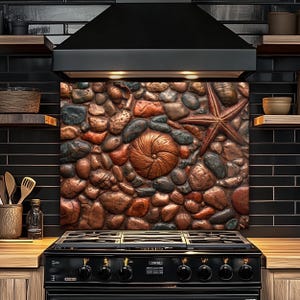 May include: A kitchen backsplash featuring a textured design of various-sized stones, seashells, and a starfish in shades of brown, red, and gray. The backsplash is installed above a black stove and beneath a black range hood.