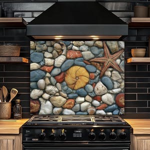 May include: A kitchen backsplash featuring a mosaic of colorful stones, seashells, and a starfish. The design incorporates shades of blue, red, orange, and cream, creating a coastal or beach-themed aesthetic. The backsplash is installed above a black stove.