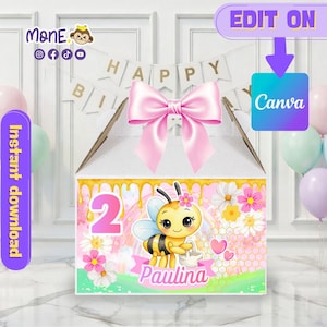 May include: A birthday-themed gift box with a cartoon bee illustration, the number 2, and the name "Paulina". The box is decorated with pink flowers, honeycombs, and a pink bow. The words "Happy Birthday" are visible.