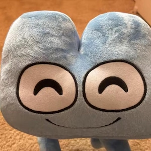 May include: A light blue plush toy shaped like the number four, featuring a soft, fuzzy texture. The character has two large, white oval eyes with black outlines and black curved eyebrows, along with a simple, thin black embroidered smile.