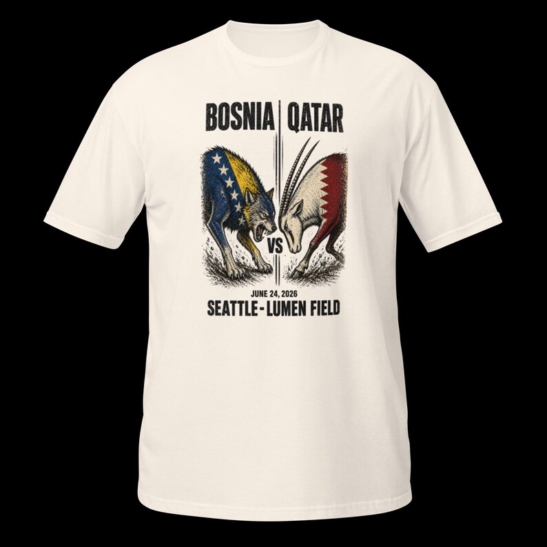 May include: Off-white t-shirt with a graphic depicting a wolf and an oryx, symbolizing Bosnia versus Qatar. The text "BOSNIA | QATAR" and "JUNE 24, 2026 SEATTLE - LUMEN FIELD" are printed above and below the illustration.