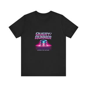 May include: Black t-shirt with a retro graphic design. The design includes the words "QUERY/RUNNER" above a database icon, and the text "OUTRUN THE OUTAGE" below. The graphic uses a neon colour scheme.