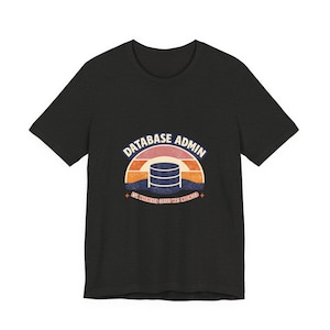 May include: Dark grey t-shirt with a retro graphic. The design includes a database server icon set within a sunset-style arc, with the words "DATABASE ADMIN" above and "EST. WHENEVER COFFEE WAS INVENTED" below. A fun, geeky design.