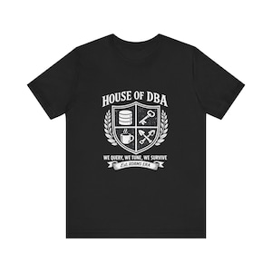 May include: Black t-shirt with a white graphic that reads "HOUSE OF DBA" above a crest design with a database, key, coffee cup, and shovel. The text "WE QUERY, WE TUNE, WE SURVIVE" is below the crest, with "Est. RDBMS ERA" below that.