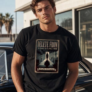 May include: A black short-sleeved t-shirt featuring a rectangular graphic print. The design depicts a silhouette of a person in a hat standing in a doorway, with the text "DELETE FROM", "The Statement That Ran Without A WHERE", and "Every Row. No Exceptions."