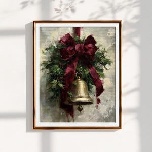 May include: An oil painting in a brown frame depicting a brass bell hanging from a cluster of green foliage adorned with a large, deep red ribbon. The artwork features visible brushstrokes and a textured, neutral-toned background behind the bell.