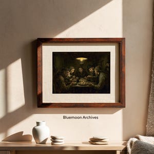 May include: A framed print of a painting depicting a group of people gathered around a table, illuminated by a single overhead light. The artwork features muted tones and a rustic aesthetic. The frame is a dark brown color. The text "Bluemooon Archives" is at the bottom.