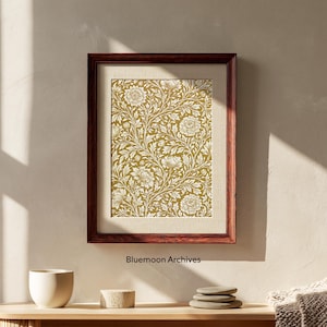 Puede incluir: Una lámina de arte mural enmarcada con un patrón floral denso e intrincado en blanco sobre un fondo amarillo mostaza. El marco rectangular es de madera marrón oscura. El texto "Bluemoon Archives" aparece debajo del marco.