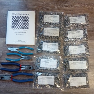 May include: A set of chainmail rings in clear plastic bags, along with a booklet titled "Chain Mail Basics: How to Knit the 4-in-1 Pattern Without Losing Your Mind or Your Patience." Three pairs of pliers are also included.