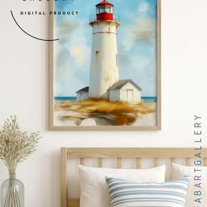 May include: A framed digital print of a lighthouse. The lighthouse is white with a red top, set against a blue sky with clouds. The print is labeled "FAB ART GALLERY DIGITAL PRODUCT". The print is displayed above a bed with pillows.