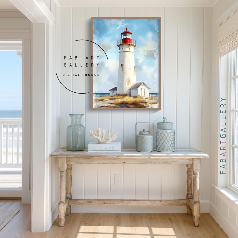 May include: A framed watercolor print of a lighthouse with a red top and white tower, set against a blue sky. The artwork is displayed above a wooden console table with decorative vases and a coral sculpture. The text "FAB ART GALLERY DIGITAL PRODUCT" is visible.