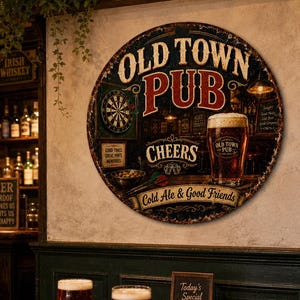 May include: A round metal wall sign featuring the text OLD TOWN PUB, CHEERS, and Cold Ale & Good Friends. The graphic depicts a dartboard, a glass of beer, and pub interior elements in shades of brown, black, red, and cream on a dark background.