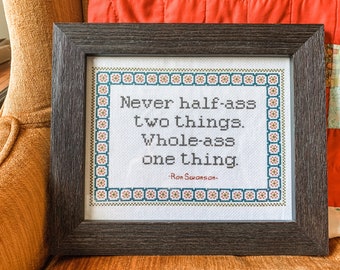May include: A framed cross-stitch with a quote by Ron Swanson: "Never half-ass two things. Whole-ass one thing."