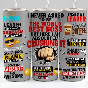 May include: Three stainless steel tumblers with humorous quotes and graphics. The designs include phrases like "The Boss," "I Never Asked to Be the World's Best Boss," and "Instant Leader." Each tumbler has a straw.