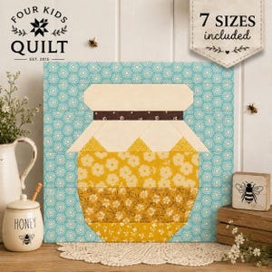 May include: A square quilt block pattern featuring a central honey jar design in yellow floral fabric against a light blue patterned background. The jar has a cream-colored lid and a dark brown band. Text on the image reads Four Kids Quilt and 7 SIZES included.